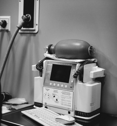 A Defibrillator on a Desk with Keyboard and Mouse